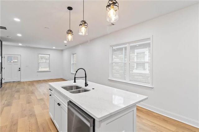 kitchen with dishwasher, sink, pendant lighting, a kitchen island with sink, and white cabinets