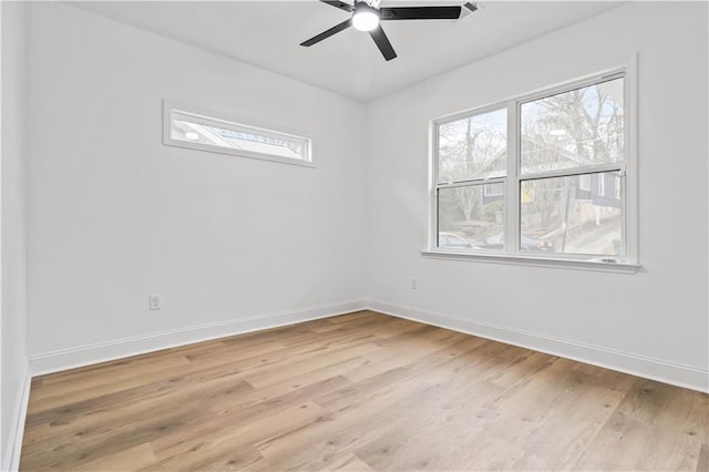 empty room with ceiling fan and light hardwood / wood-style flooring