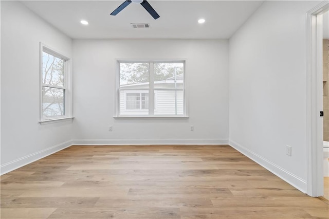 empty room with ceiling fan and light wood-type flooring