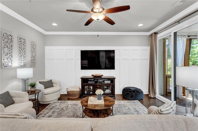 living room featuring ceiling fan, dark hardwood / wood-style flooring, and ornamental molding