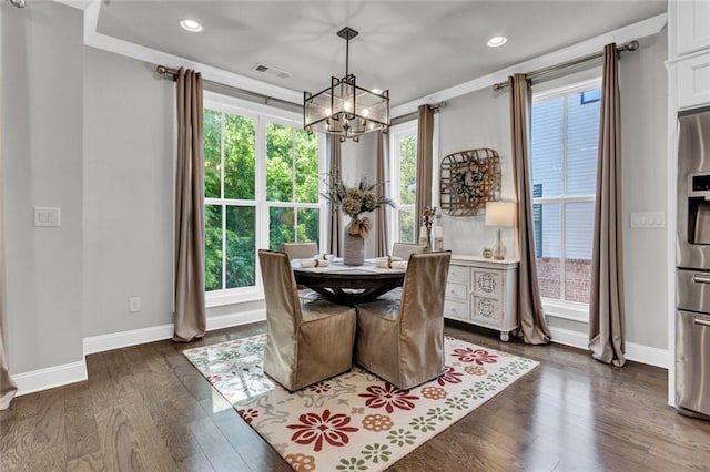 dining area with a chandelier, a healthy amount of sunlight, and dark wood-type flooring