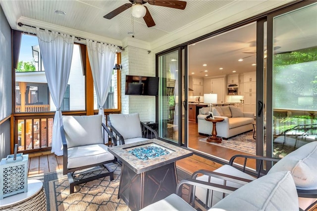 sunroom featuring ceiling fan