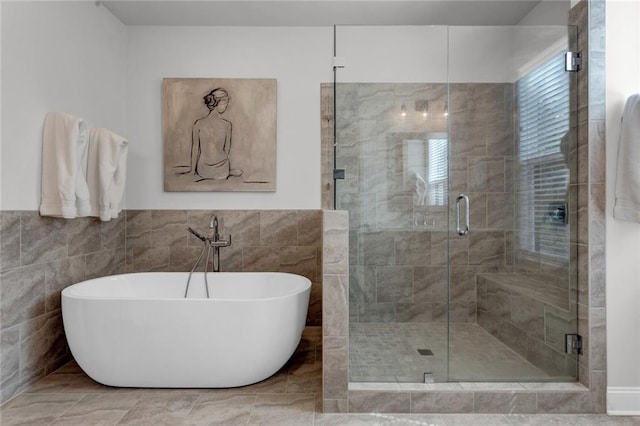 bathroom with tile walls, plus walk in shower, and tile floors