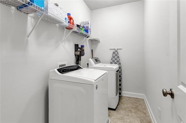 laundry area featuring washer hookup, separate washer and dryer, and light tile floors