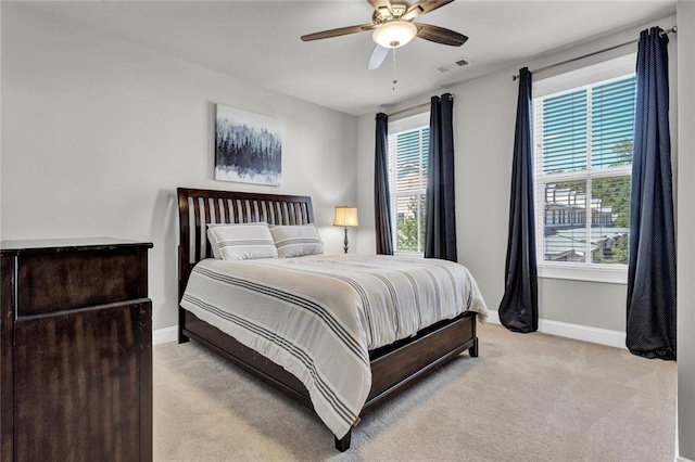 bedroom featuring light carpet and ceiling fan