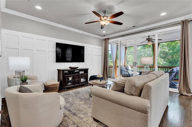 living room featuring ceiling fan, ornamental molding, and dark hardwood / wood-style floors