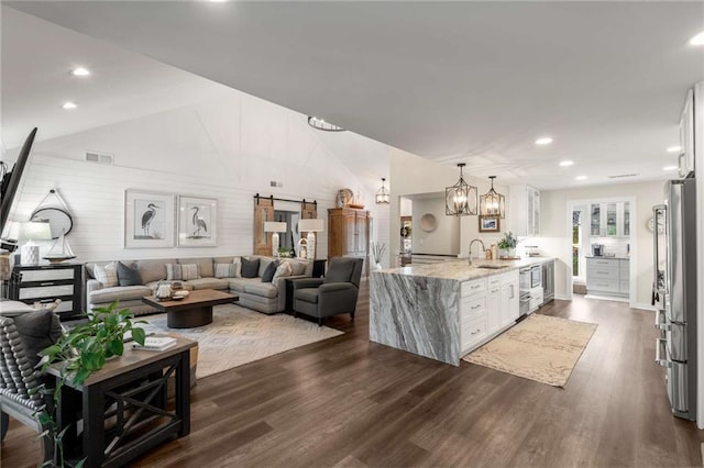 living room featuring visible vents, dark wood-style floors, high vaulted ceiling, recessed lighting, and a notable chandelier