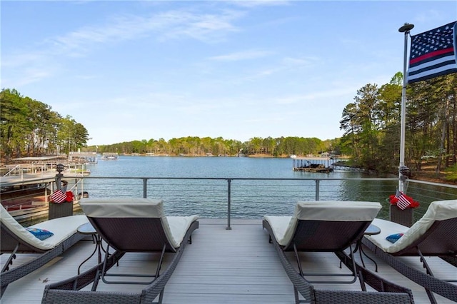 dock area with a water view and a balcony