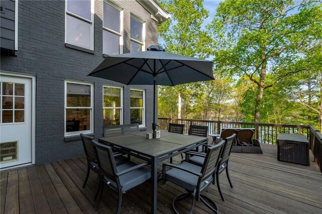 wooden terrace with outdoor dining space