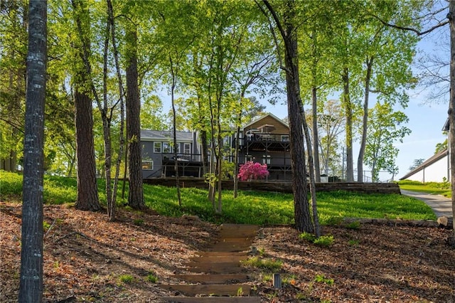 view of water feature with a forest view and a dock