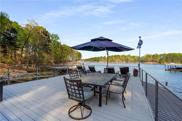birds eye view of property with a water view and a wooded view