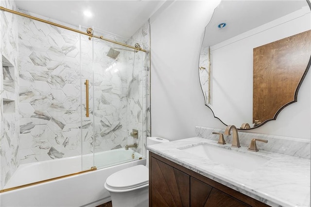 full bathroom with combined bath / shower with glass door, vanity, and toilet