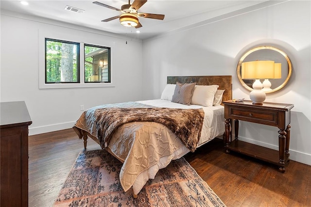 bedroom with ceiling fan and dark hardwood / wood-style floors