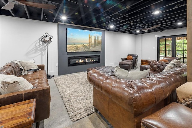 living room featuring ceiling fan and concrete floors