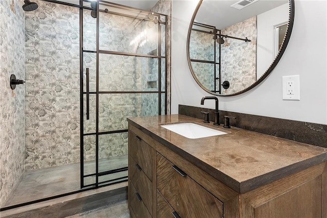 bathroom with walk in shower, hardwood / wood-style flooring, and vanity