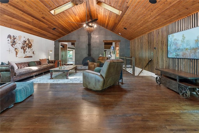 living room featuring ceiling fan, a wood stove, lofted ceiling with skylight, wooden ceiling, and dark hardwood / wood-style flooring