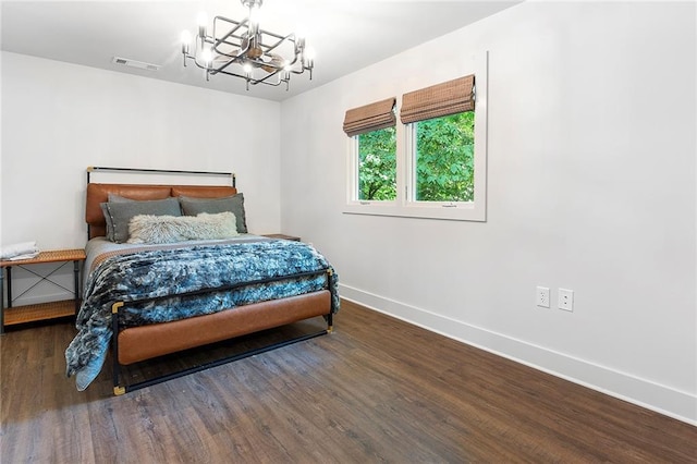 bedroom featuring a notable chandelier and dark hardwood / wood-style floors