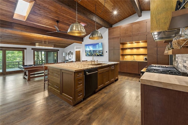 kitchen featuring dark wood-type flooring, black dishwasher, pendant lighting, vaulted ceiling with skylight, and a kitchen island with sink