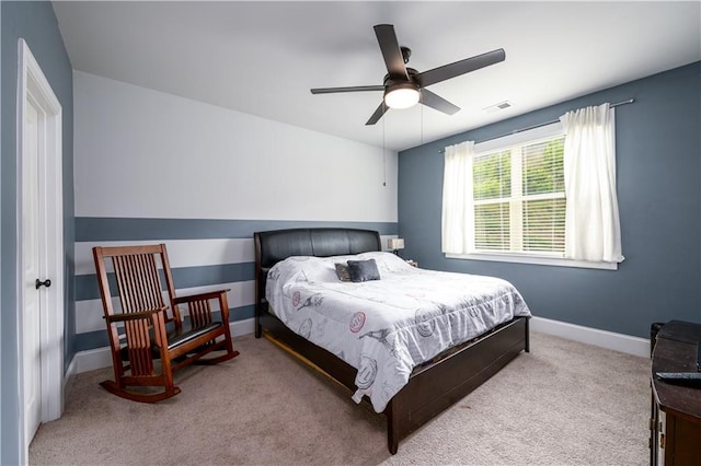 carpeted bedroom featuring baseboards and a ceiling fan