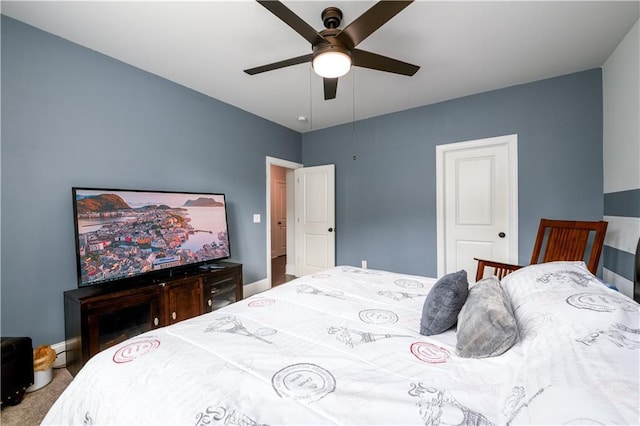 carpeted bedroom with baseboards and a ceiling fan