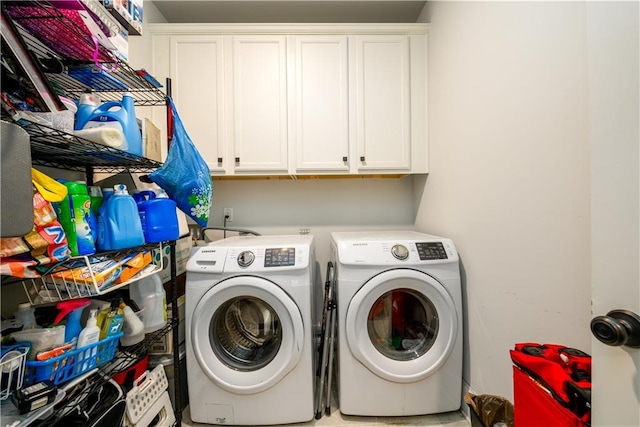 clothes washing area with cabinet space and washer and dryer
