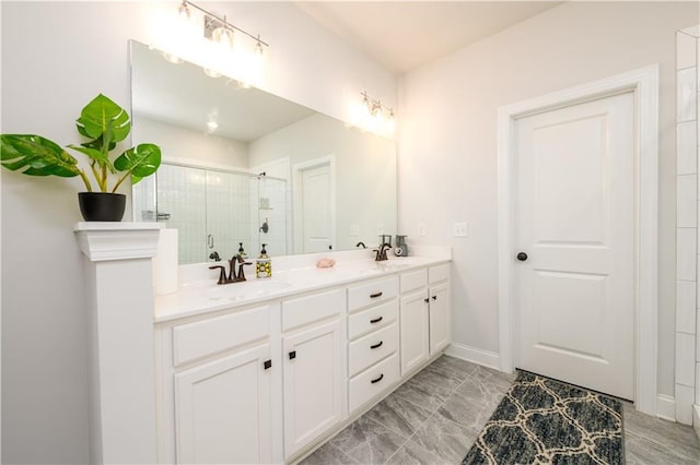 bathroom featuring a shower stall and double vanity