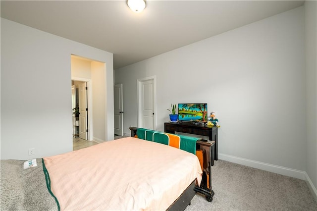 bedroom featuring baseboards and light carpet