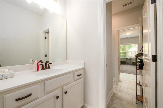 bathroom with vanity and baseboards