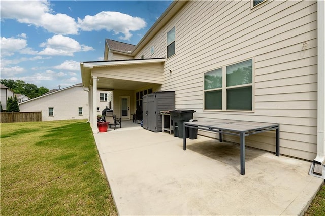 rear view of property with a patio area and a lawn