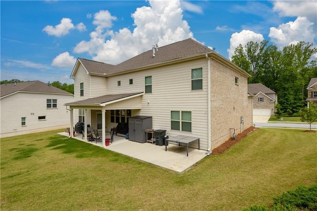 rear view of house featuring a patio area and a yard