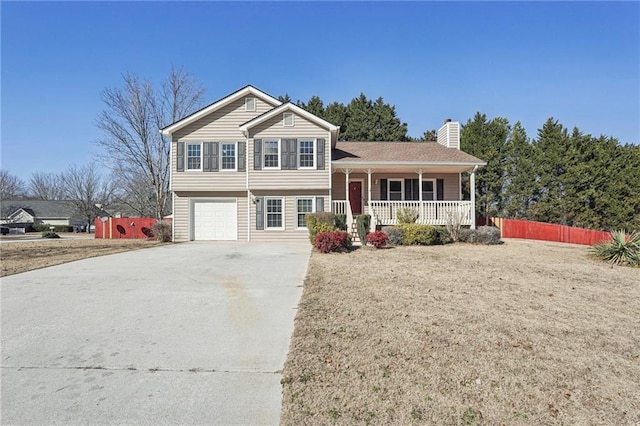 tri-level home featuring a porch and a garage