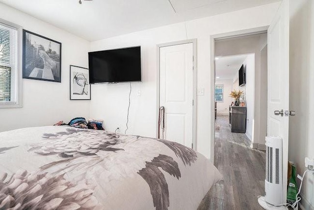 bedroom with attic access and wood finished floors