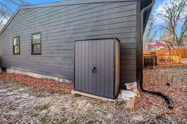 view of side of home featuring fence