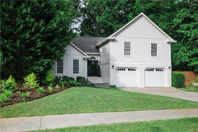 2986 Edenberry Ln NW, Kennesaw, GA 30152 - view of front of home with board and batten siding, an attached garage, concrete driveway, and a front lawn