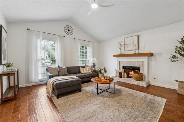 2986 Edenberry Ln NW, Kennesaw, GA 30152 - living room featuring a ceiling fan, dark wood-style floors, lofted ceiling, a fireplace, and baseboards