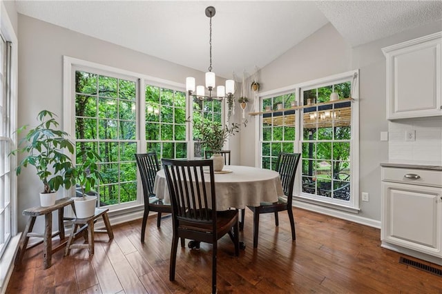 2986 Edenberry Ln NW, Kennesaw, GA 30152 - dining space featuring vaulted ceiling, healthy amount of natural light, dark wood-style floors, a chandelier, and baseboards