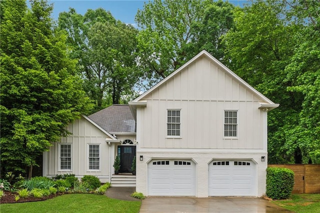 2986 Edenberry Ln NW, Kennesaw, GA 30152 - view of front of home featuring board and batten siding, driveway, a garage, roof with shingles, and fence