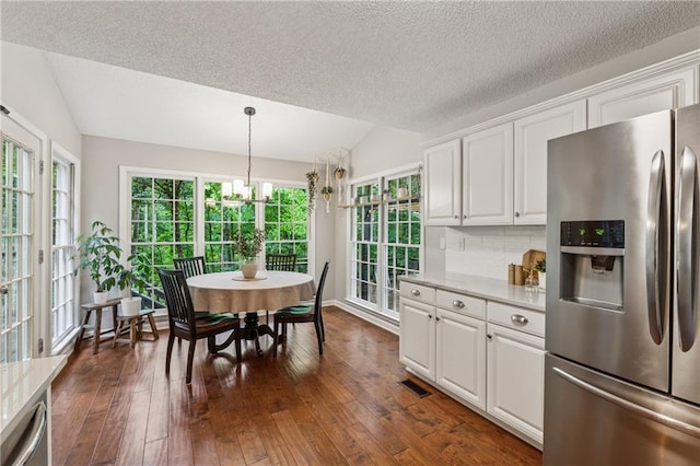 2986 Edenberry Ln NW, Kennesaw, GA 30152 - kitchen featuring stainless steel fridge, lofted ceiling, light countertops, dark wood-type flooring, and white cabinets