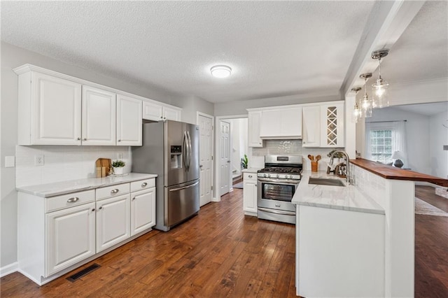 2986 Edenberry Ln NW, Kennesaw, GA 30152 - kitchen with stainless steel appliances, a sink, a peninsula, white cabinetry, and dark wood-style floors