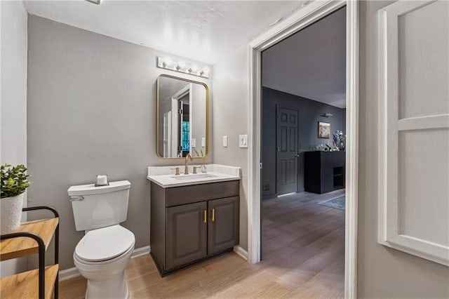 2986 Edenberry Ln NW, Kennesaw, GA 30152 - bathroom with wood finished floors, toilet, vanity, and baseboards