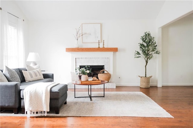 2986 Edenberry Ln NW, Kennesaw, GA 30152 - living room featuring wood finished floors, a fireplace, lofted ceiling, and baseboards