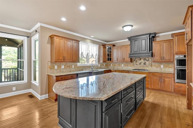 17 River Walk Pkwy, Euharlee, GA 30145 - kitchen with a sink, appliances with stainless steel finishes, baseboards, light wood-type flooring, and tasteful backsplash