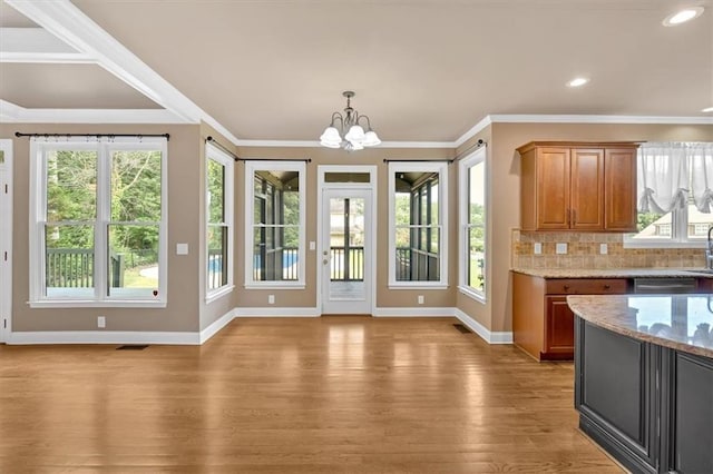 17 River Walk Pkwy, Euharlee, GA 30145 - kitchen with baseboards, light wood-style flooring, a chandelier, plenty of natural light, and ornamental molding