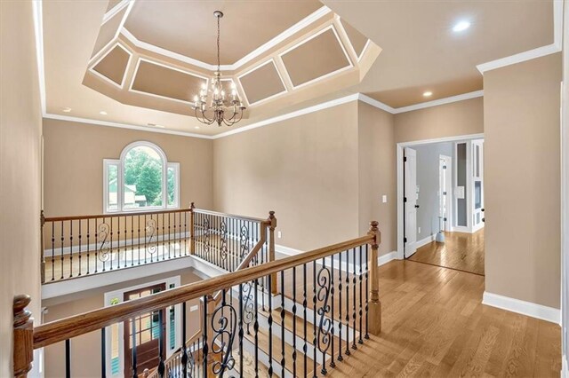 17 River Walk Pkwy, Euharlee, GA 30145 - corridor with an upstairs landing, wood finished floors, a chandelier, crown molding, and recessed lighting