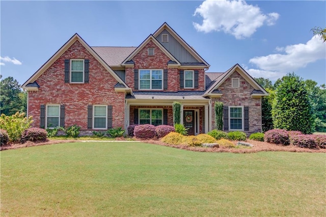 craftsman-style house featuring a front lawn and brick siding