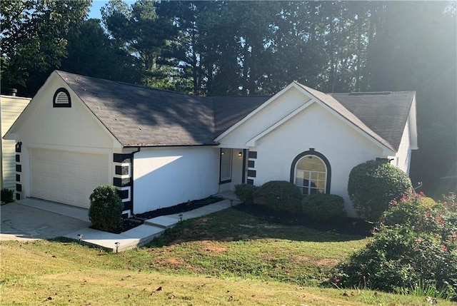 single story home with a front yard and a garage