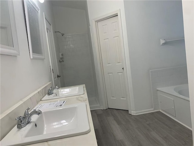 bathroom featuring hardwood / wood-style floors, separate shower and tub, and sink