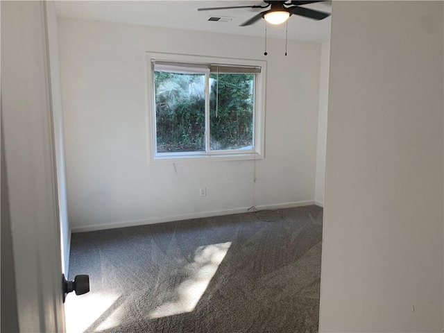 empty room featuring ceiling fan and carpet