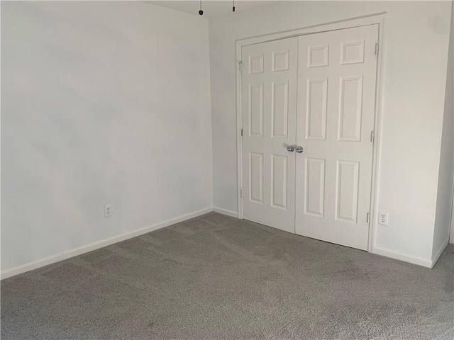 unfurnished bedroom featuring carpet and a closet