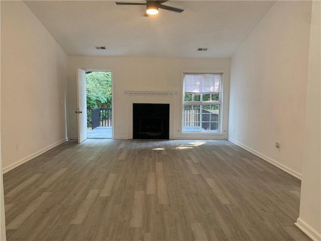 unfurnished living room featuring ceiling fan and wood-type flooring